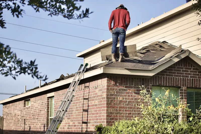 Professional roofer working on a residential roof in Lamoreaux Landing